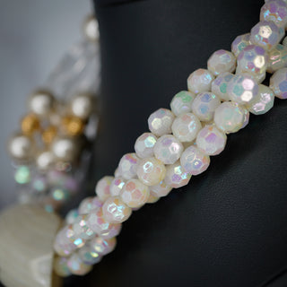 Elevate your style with the Ocean’s Majesty: Layered Shell & Faux Pearl Statement Necklace, a stunning accessory.