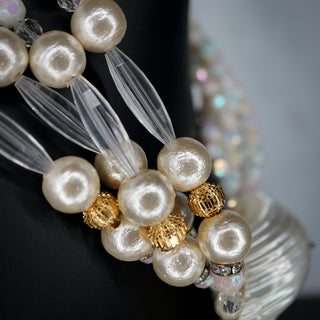 Elegant Ocean’s Majesty: Layered Shell & faux pearl statement necklace showcasing shimmering textures and unique design.