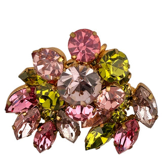Multicolored gemstone brooch on a light gray background