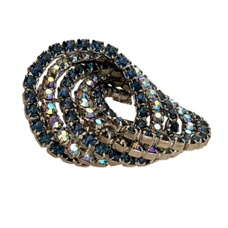 Decorative brooch with blue gemstones on a light background