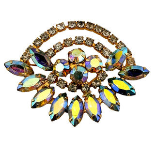 Multicolored jeweled brooch on a light background
