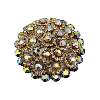 Multicolored rhinestone brooch on a light gray background