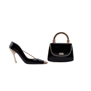 Black high-heeled shoe and matching handbag on a light gray background