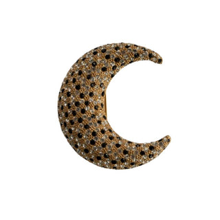 A vintage crescent moon-shaped brooch adorned with pave-set clear and black rhinestones, with a brushed gold-plated finish.