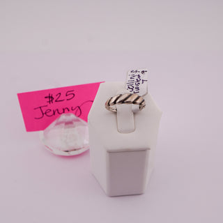 A silver-toned twisted rope ring displayed on a white jewelry stand, with handwritten price tags attached. A pink tag reads '$25 Jenny' and a white tag shows the seller's details.