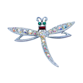 A vintage silvertone brooch in the shape of a dragonfly, featuring a colorful aurora borealis crystal body and green and red enamel details.