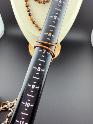 Close-up of a black ruler with measurement markings on a dark background