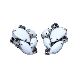 A pair of vintage clip-on earrings featuring white cabochons and gold-tone metal with rhinestone accents.