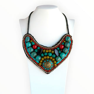 Colorful beaded necklace on a mannequin with a white background