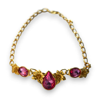 A vintage Trifari necklace with gold-tone metal and pink crystal stones, featuring a signed Kunio Matsumoto design.