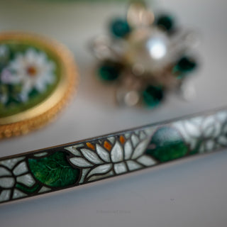 Decorative item with floral design on a white surface