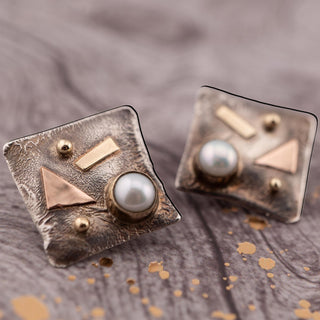 Reserved Grace abstract earrings in sterling silver, yellow and rose gold with a bezel-set pearl and omega post back.