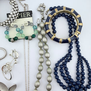 Reserved Grace assorted fashion jewelry set featuring navy blue bangles, beaded necklaces, and silver-tone accessories.