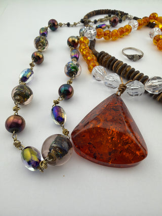Reserved Grace beaded necklace set featuring a large amber pendant, wood discs, glass beads, and a sterling silver ring.