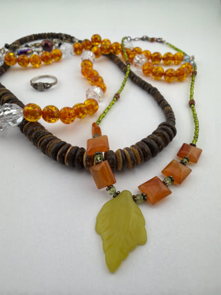 Reserved Grace beaded necklace set with amber beads, wood discs, green leaf pendant, and a sterling silver ring.