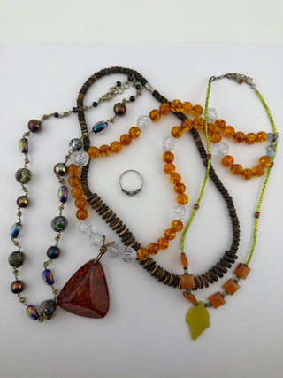 Reserved Grace beaded necklace collection featuring amber, wood, and glass beads with a sterling silver ring