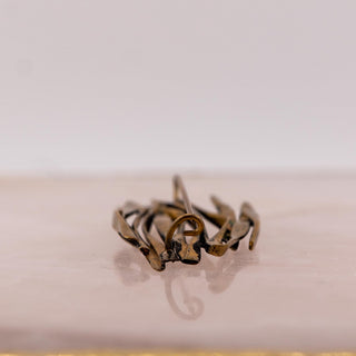 Reserved Grace vintage gold-tone brutalist brooch with an organic, twig-like design shown from the back pin side.