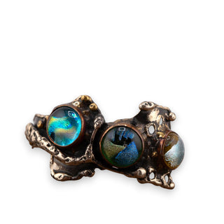Reserved Grace artisan brutalist bracelet featuring three iridescent dichroic glass cabochons in a silver tone setting.