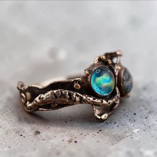 Reserved Grace artisan brutalist bracelet featuring textured silver tone metal and iridescent dichroic glass cabochons.