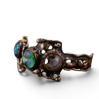 Reserved Grace artisan brutalist cuff bracelet featuring iridescent dichroic glass cabochons in a textured silver tone