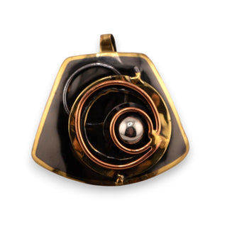 Reserved Grace brutalist pendant featuring layered bronze and copper spiral details on a dark metal base.