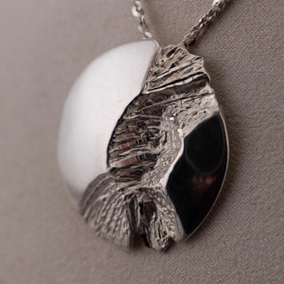Reserved Grace vintage sterling silver Brutalist pendant featuring a polished and molten reticulated textured finish.