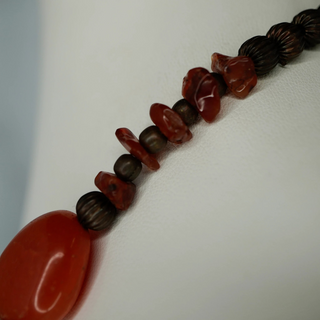 Reserved Grace vintage necklace with polished carnelian beads and dark metal spacer beads on a white display bust.