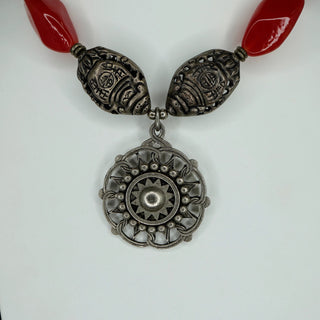 Reserved Grace artisan necklace featuring a red carnelian medallion pendant with intricate sterling silver detailing.