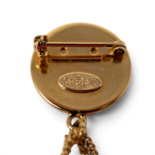 Reserved Grace vintage Chanel gold-tone brooch back view showing the 1995 hallmark and pin closure mechanism.