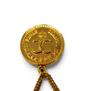 Reserved Grace vintage Chanel gold-tone brooch featuring a 31 Rue Cambon coin medallion and dangling handbag charm.