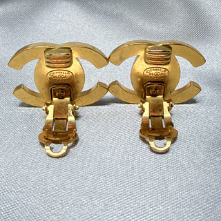 Reserved Grace vintage Chanel gold-plated CC turn lock clip-on earrings showing the back stamp and mechanism
