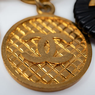 Reserved Grace vintage Chanel gold-plated CC medallion coin charm with quilted texture and black resin accent