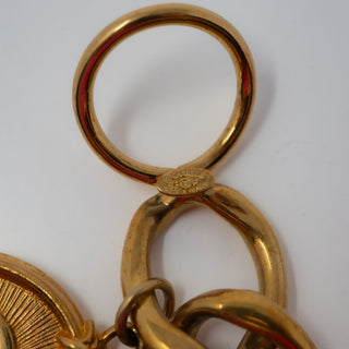 Reserved Grace vintage Chanel gold-plated charm bracelet showing the hallmark stamp on the circular toggle clasp
