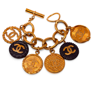 Reserved Grace vintage Chanel gold-plated charm bracelet featuring CC logo medallions and black resin accents.