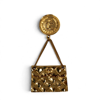 Reserved Grace vintage Chanel gold-tone brooch featuring a 31 Rue Cambon coin medallion and dangling quilted bag charm