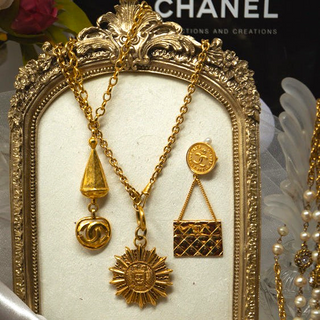 Reserved Grace vintage Chanel gold-plated sunburst medallion necklace with iconic CC logo on a long chain