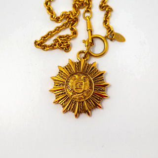 Reserved Grace vintage Chanel gold-plated sunburst medallion pendant necklace on a long chain.