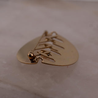 Reserved Grace gold tone abstract cut out brooch with mixed finish and pearl detail, 1.5 by 2 inch pin back view.