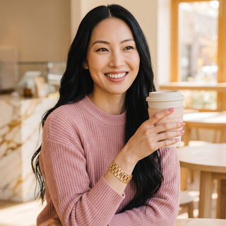 Reserved Grace Sarah Coventry gold tone chain link bracelet worn by a smiling woman in a pink sweater