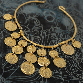 Reserved Grace chunky gold-tone bib choker necklace featuring cascading ancient Greek coin charms on a rigid collar.