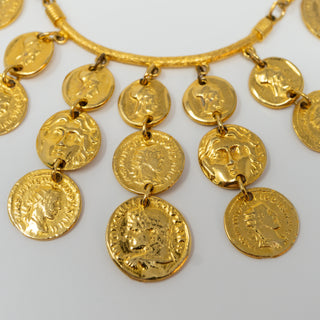 Reserved Grace gold-tone chunky coin choker bib necklace with intricate classical motifs on a rigid collar