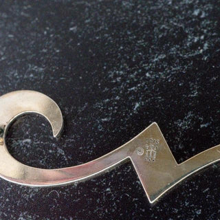 Reserved Grace James Avery sterling silver swirl brooch showing the hallmark and polished metal finish