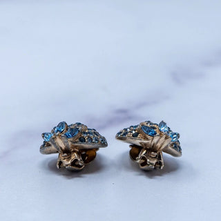 Reserved Grace vintage Jomaz gold-tone clip-on earrings featuring architectural blue rhinestone clusters.