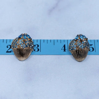 Reserved Grace vintage Jomaz gold-tone clip-on earrings featuring clusters of bright blue rhinestones on a measuring tape