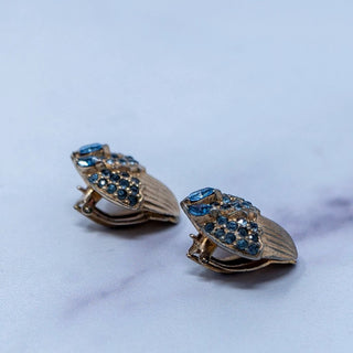 Reserved Grace vintage Jomaz gold-tone clip-on earrings featuring architectural design with blue rhinestones.