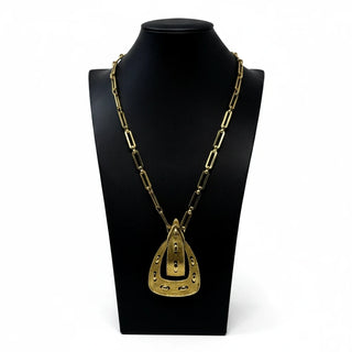 Reserved Grace vintage 1970s Monet gold-tone link necklace featuring a textured belt buckle pendant on a display bust
