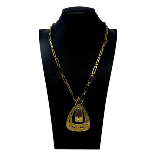 Reserved Grace vintage 1970s Monet gold-tone link necklace featuring a decorative belt buckle pendant on a display
