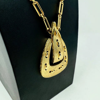 Reserved Grace vintage 1970s Monet gold-tone metal necklace featuring a textured belt buckle pendant on a link chain.