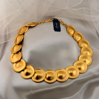 Reserved Grace vintage Monet gold-tone matte disk necklace featuring a linked circular design on white fabric.