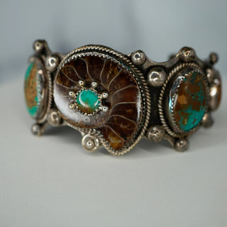 Reserved Grace vintage Navajo sterling silver cuff bracelet featuring a central ammonite fossil and Royston turquoise.